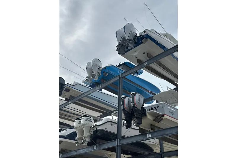 Slide: The Image of 2024 Sea Hunt Ultra 305 SE boats stacked in a marina storage facility. - 22