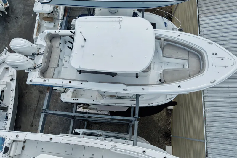 Slide: The Image of 2024 Sea Hunt Ultra 305 SE boat, aerial view, showcasing spacious seating and dual engines. - 23