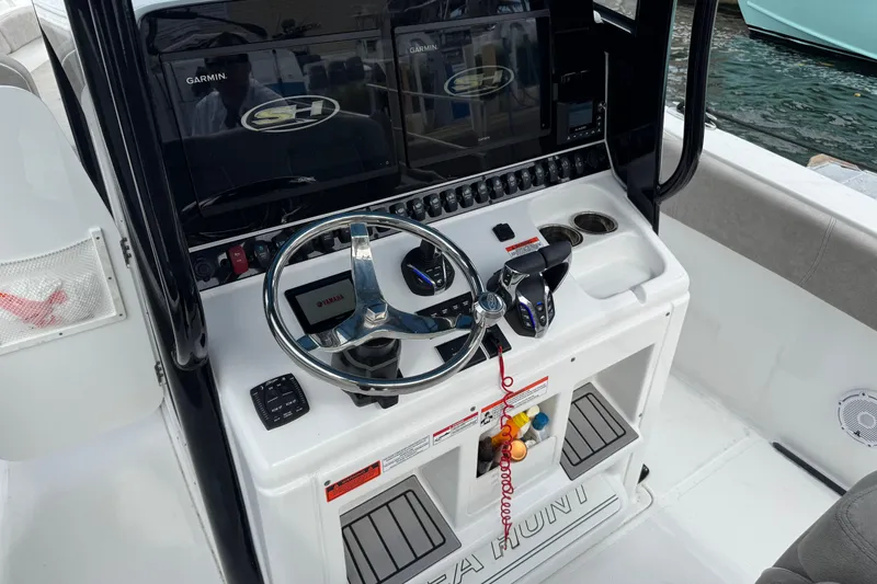 Slide: The Image of 2024 Sea Hunt Ultra 305 SE boat console with Garmin displays and Yamaha controls. - 4