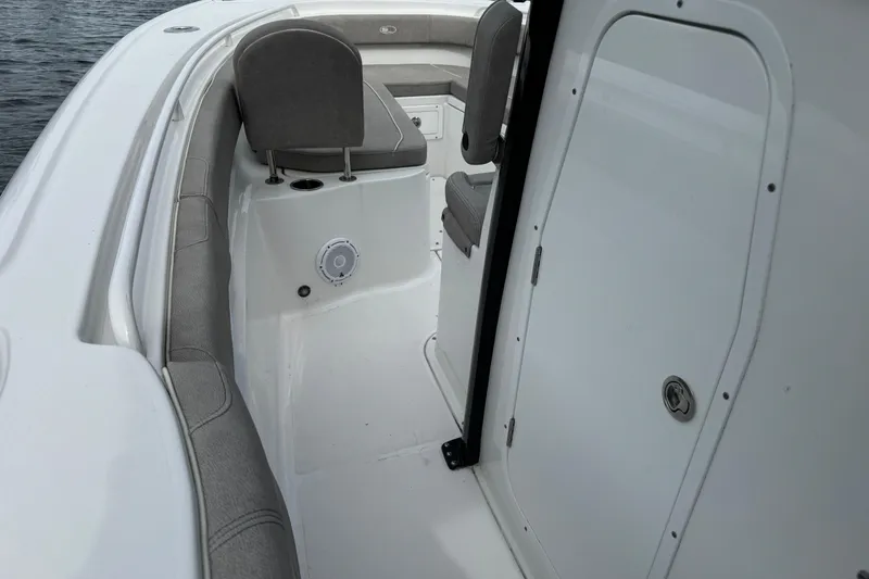 Slide: The Image of 2024 Sea Hunt Ultra 305 SE boat interior with seating and storage. - 5