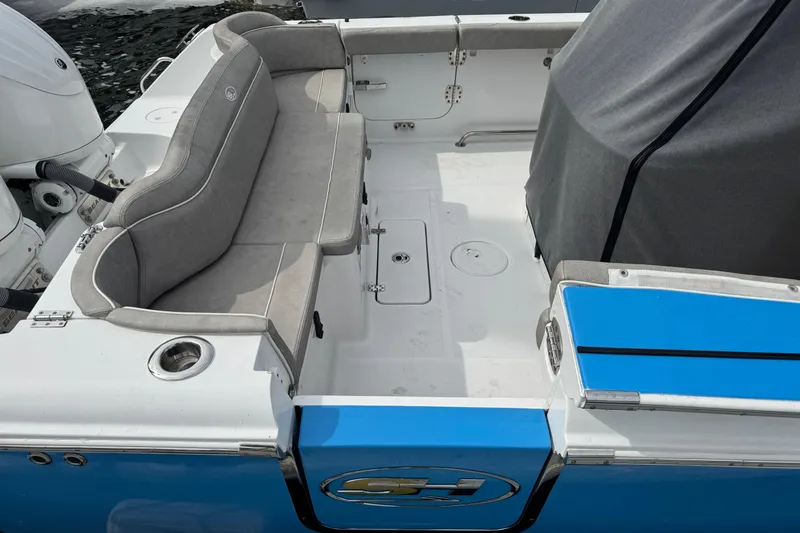 Slide: The Image of 2024 Sea Hunt Ultra 305 SE boat interior with gray seating and blue accents. - 8