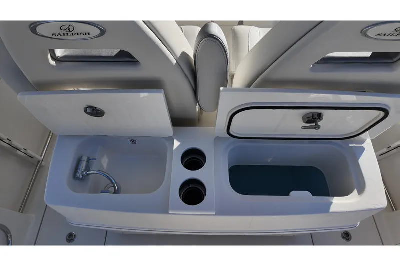 Slide: The Image of 2026 Sailfish 272 SE boat interior with sink, storage, and cup holders. - 16