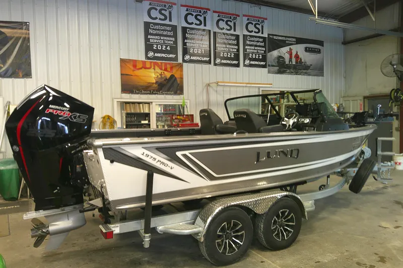 The Image of Lund 1975 Pro-V 2025 fishing boat in showroom with Mercury Pro XS engine. - 0