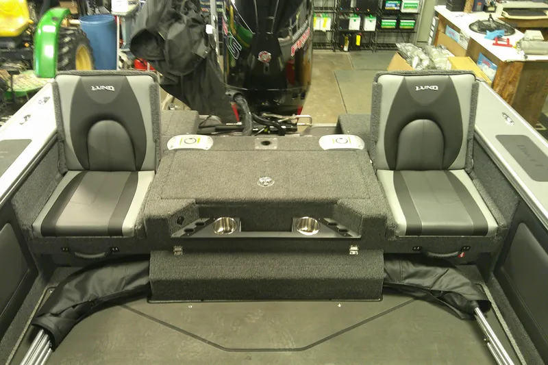 Slide: The Image of Interior of 2025 Lund 1975 Pro-V boat with dual seats and storage compartments. - 10