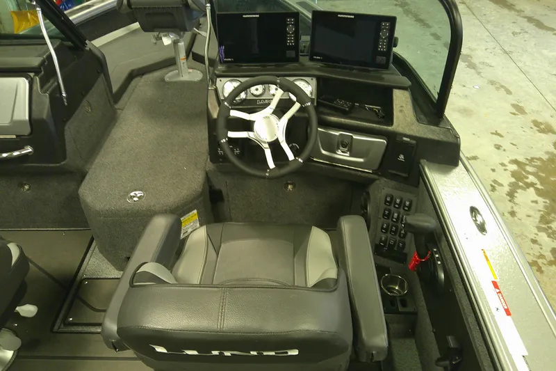 Slide: The Image of Interior of 2025 Lund 1975 Pro-V boat with modern steering and control panels. - 13