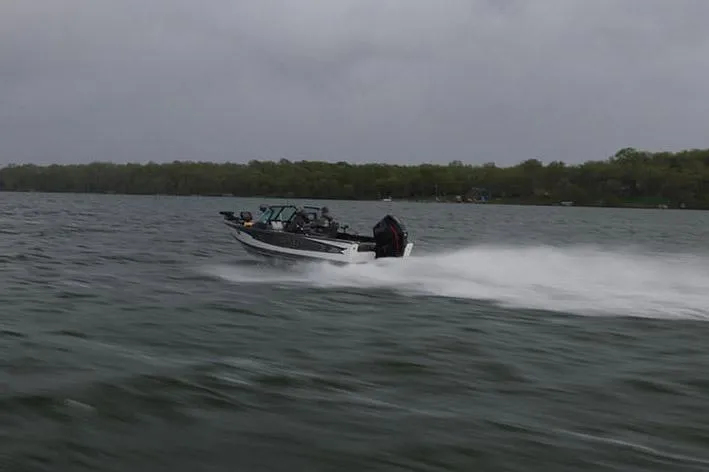 Slide: The Image of Manufacturer Provided Image: Lund 1975 Pro-V boat speeding on a lake, 2025 model. - 16