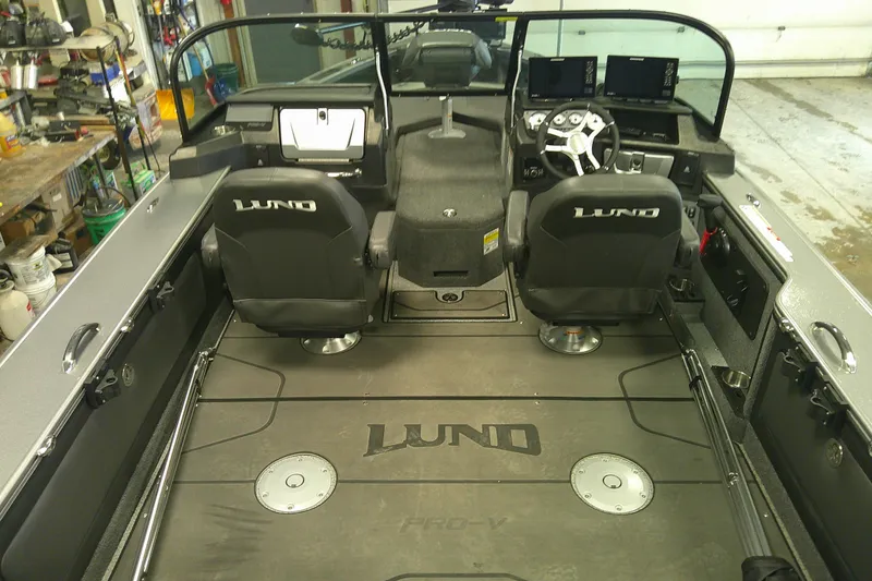 Slide: The Image of Interior of 2025 Lund 1975 Pro-V boat with dual seats and modern dashboard. - 4