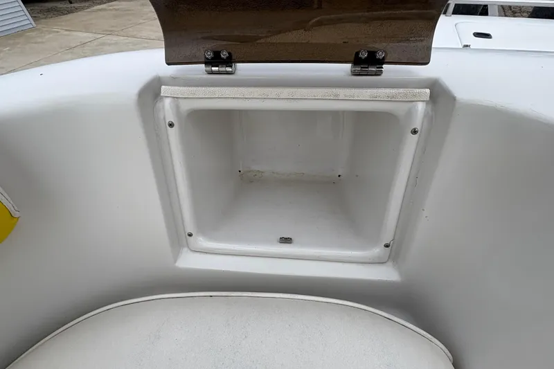 Slide: The Image of Open storage compartment on a 2003 Splendor 240 Platinum boat. - 13