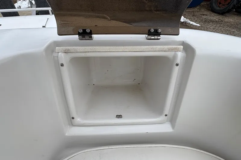 Slide: The Image of Open storage compartment on a 2003 Splendor 240 Platinum boat. - 14