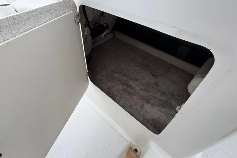 Slide: The Image of Open storage compartment in 2003 Splendor 240 Platinum boat, showing interior space. - 22