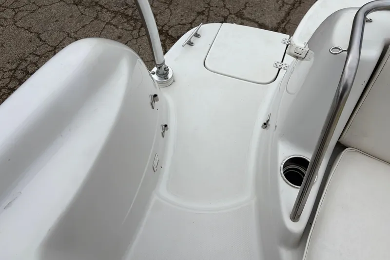 Slide: The Image of 2003 Splendor 240 Platinum boat interior with white seating and stainless steel railing. - 28