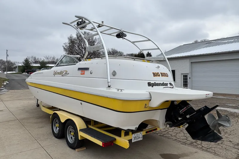Slide: The Image of 2003 Splendor 240 Platinum boat on trailer, featuring yellow accents and dual propellers. - 4