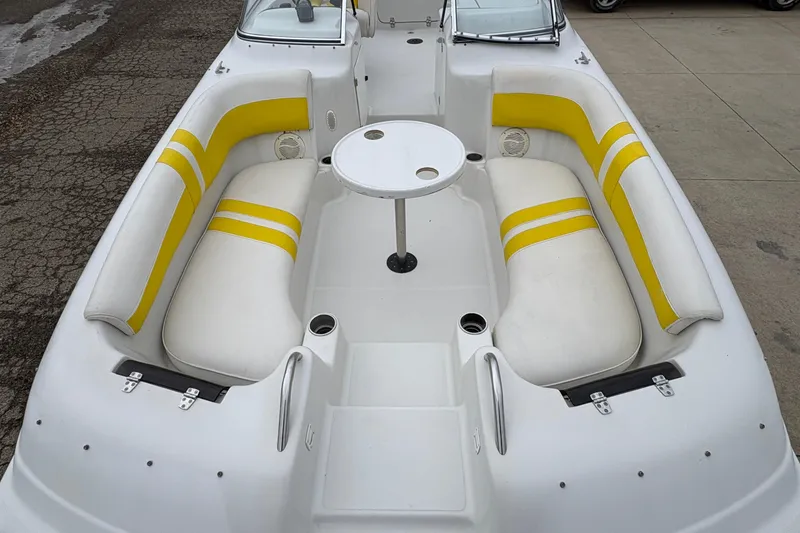 Slide: The Image of 2003 Splendor 240 Platinum boat interior with yellow and white seating and central table. - 9