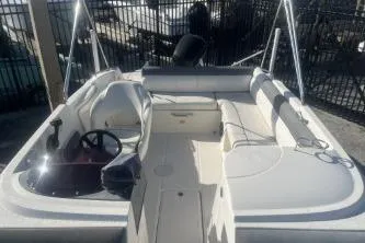 Slide: The Image of 2018 Bayliner 210 Deck Boat with spacious seating and sleek design. - 9