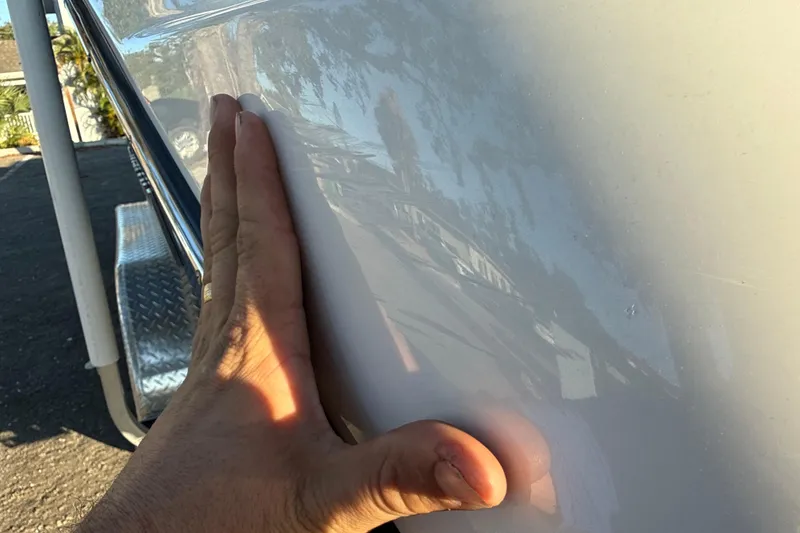 Slide: The Image of Hand touching the smooth surface of a 2021 Yamaha Boats 252S. - 11