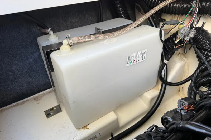 Slide: The Image of 2021 Yamaha Boats 252S engine compartment with wiring and fluid reservoir. - 17