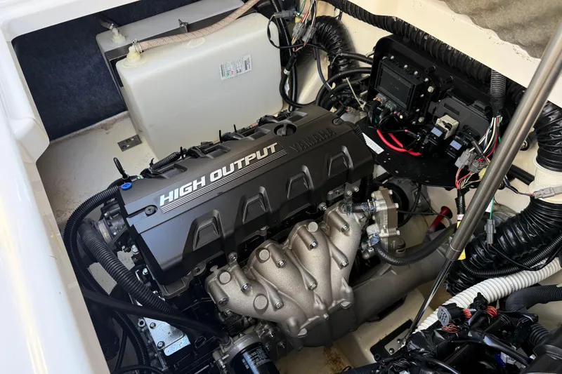 Slide: The Image of Engine compartment of a 2021 Yamaha Boats 252S, featuring a high output motor. - 18