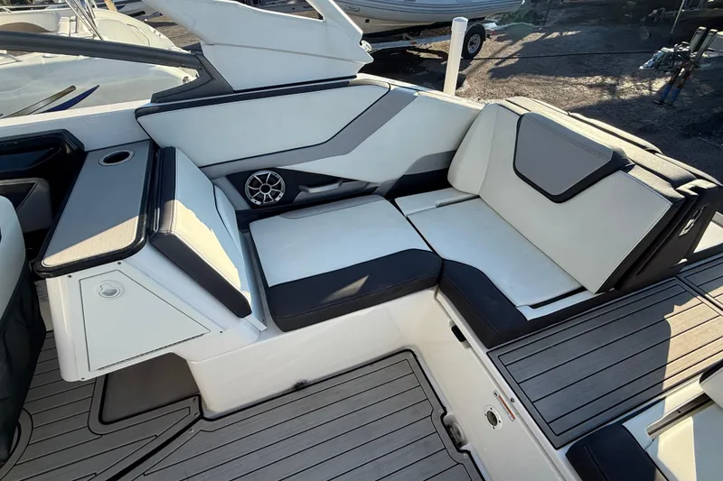Slide: The Image of 2021 Yamaha Boats 252S interior seating with sleek design and integrated speaker system. - 23