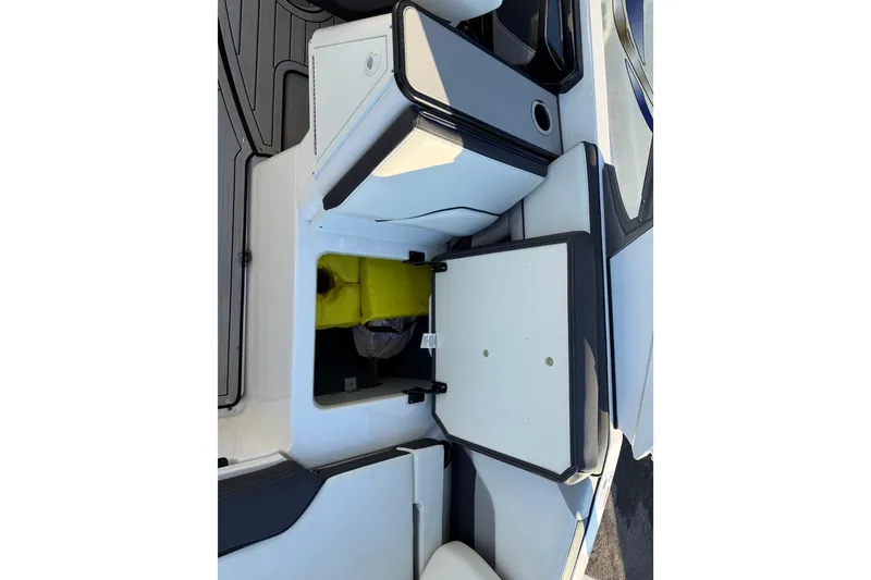 Slide: The Image of 2021 Yamaha Boats 252S interior storage compartment with open hatch, showcasing seating and storage space. - 24