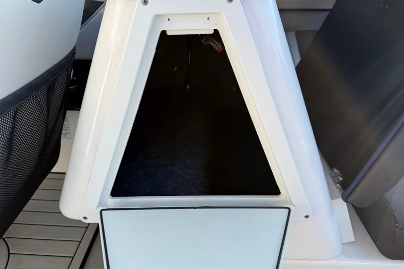 Slide: The Image of 2021 Yamaha Boats 252S storage compartment with open hatch, showcasing interior space. - 28