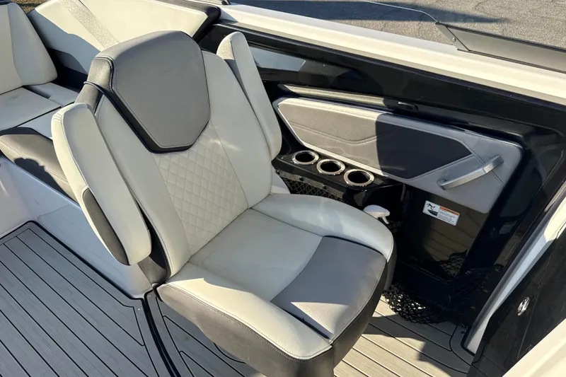 Slide: The Image of 2021 Yamaha Boats 252S interior with cushioned seating and cup holders. - 35