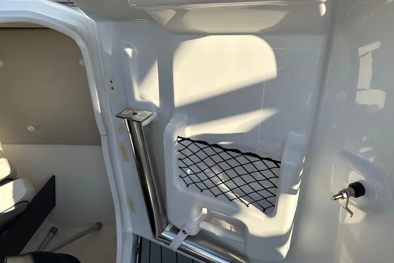 Slide: The Image of Interior view of 2021 Yamaha Boats 252S, featuring storage net and sleek design. - 38