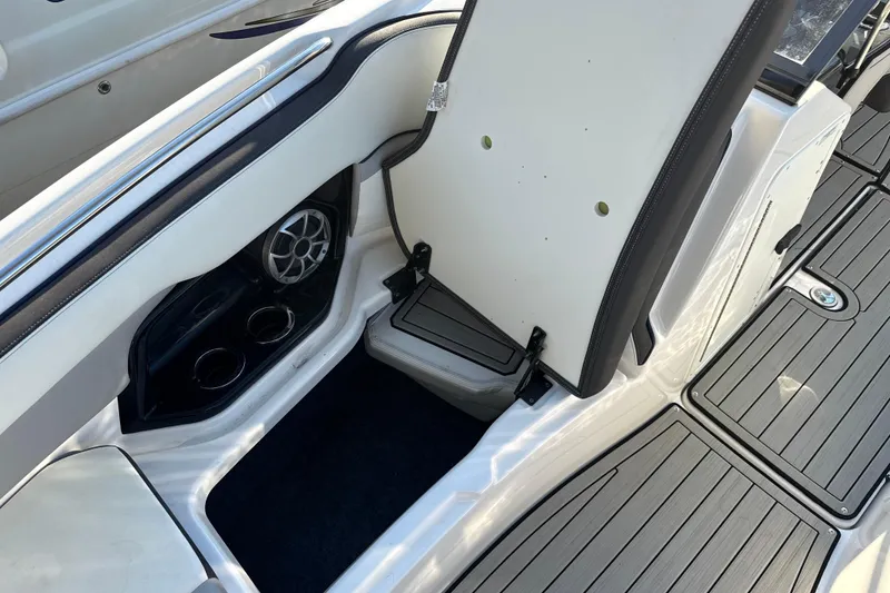 Slide: The Image of 2021 Yamaha Boats 252S interior with speaker, cup holders, and seating area. - 45