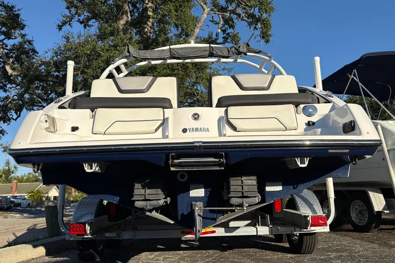 Slide: The Image of 2021 Yamaha Boats 252S on trailer, rear view, parked outdoors. - 9