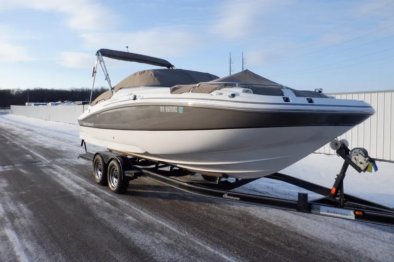 The Image of 2013 Hurricane SunDeck 2400 IO boat on trailer in snowy setting. - 0