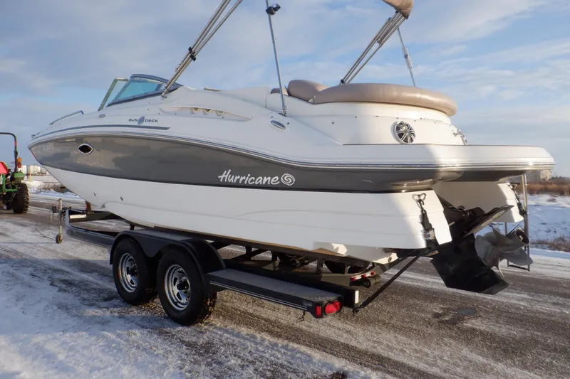 Slide: The Image of 2013 Hurricane SunDeck 2400 IO boat on trailer in snowy setting. - 10