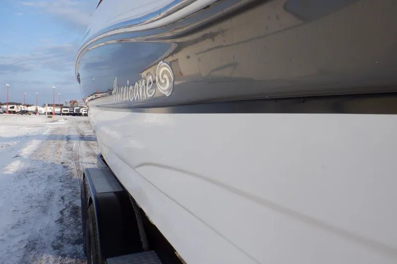 Slide: The Image of 2013 Hurricane SunDeck 2400 IO boat on trailer in snowy setting. - 11
