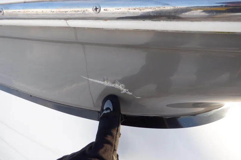 Slide: The Image of Close-up of a scratch on a 2013 Hurricane SunDeck 2400 IO boat hull. - 12