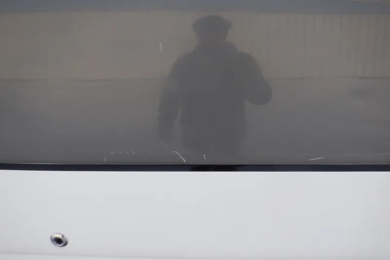 Slide: The Image of Reflection on 2013 Hurricane SunDeck 2400 IO boat surface. - 14