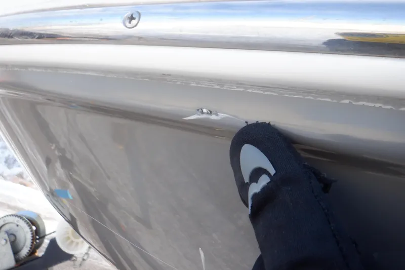 Slide: The Image of Close-up of 2013 Hurricane SunDeck 2400 IO boat with hull damage. - 15