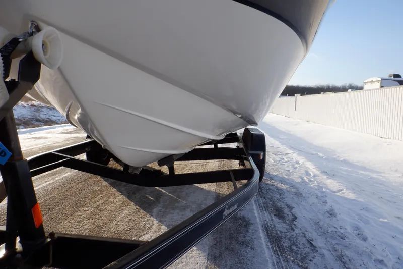 Slide: The Image of 2013 Hurricane SunDeck 2400 IO boat on trailer in snowy setting. - 17