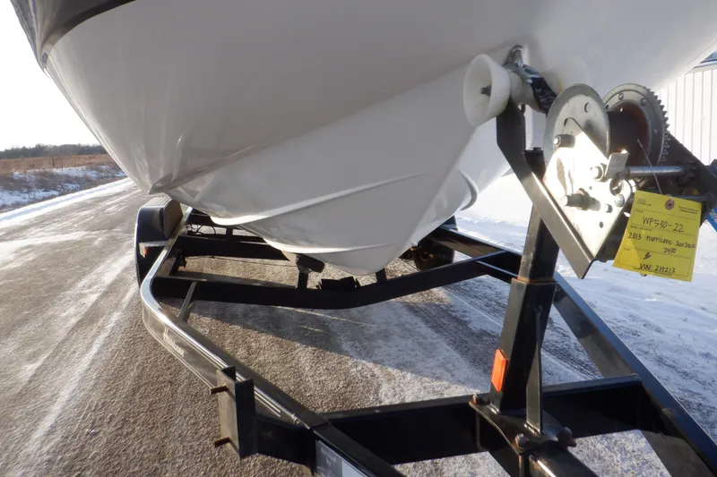Slide: The Image of 2013 Hurricane SunDeck 2400 IO boat on trailer, close-up view. - 18
