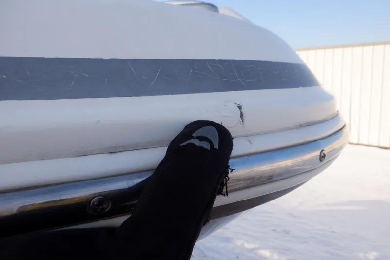 Slide: The Image of Close-up of 2013 Hurricane SunDeck 2400 IO boat with minor hull damage. - 20