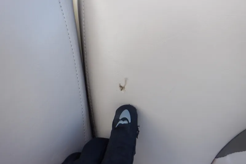 Slide: The Image of Small tear on 2013 Hurricane SunDeck 2400 IO boat upholstery. - 26