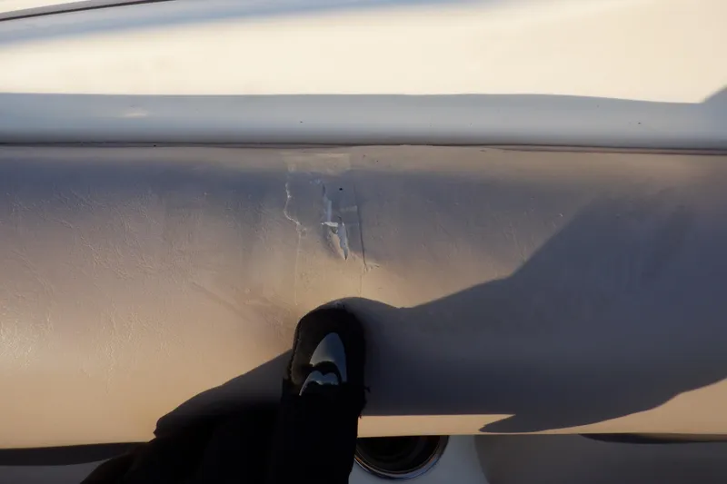 Slide: The Image of Close-up of damage on 2013 Hurricane SunDeck 2400 IO boat hull. - 27