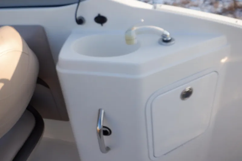 Slide: The Image of 2013 Hurricane SunDeck 2400 IO boat sink and storage compartment. - 28