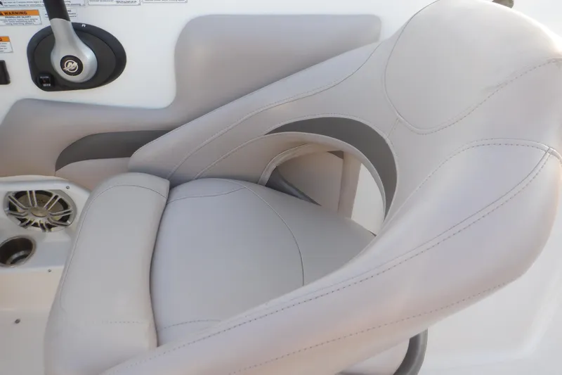 Slide: The Image of 2013 Hurricane SunDeck 2400 IO boat seat with steering wheel and speaker. - 29