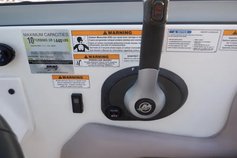 Slide: The Image of 2013 Hurricane SunDeck 2400 IO control panel with warning labels and capacity information. - 30