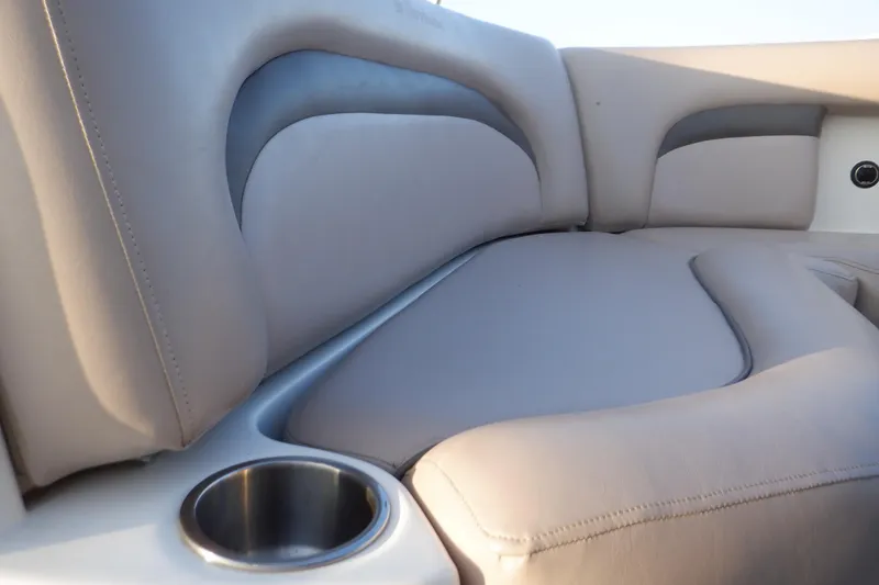 Slide: The Image of 2013 Hurricane SunDeck 2400 IO boat interior with cushioned seating and cup holder. - 33