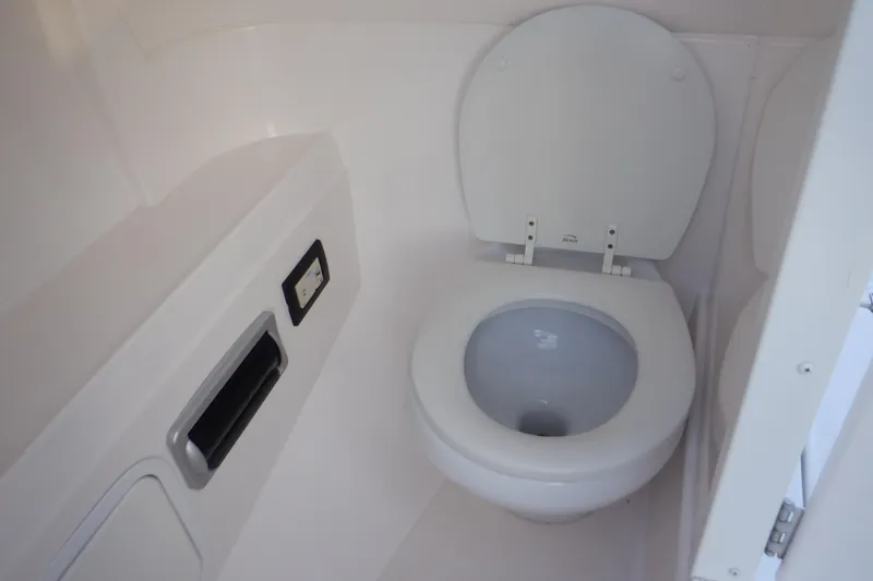 Slide: The Image of 2013 Hurricane SunDeck 2400 IO boat bathroom interior with toilet. - 36