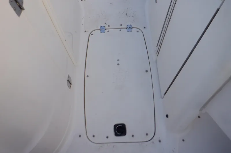 Slide: The Image of 2013 Hurricane SunDeck 2400 IO boat deck hatch, white surface with hinges and latch. - 37