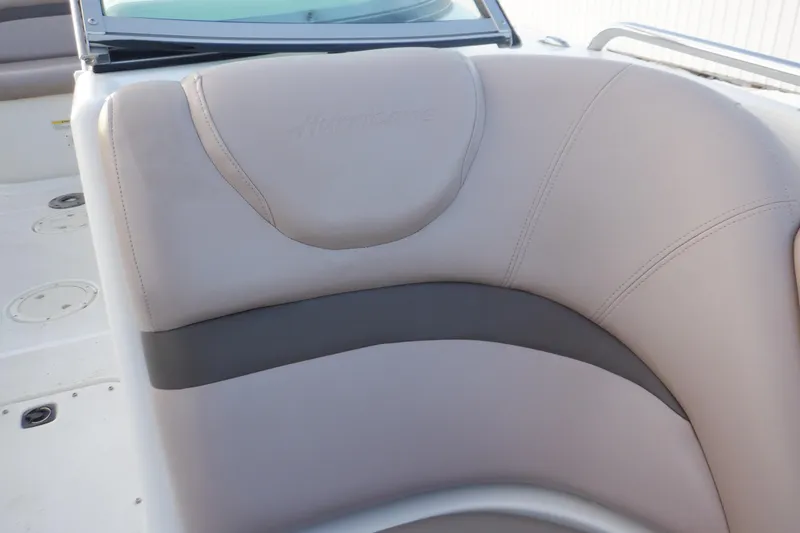 Slide: The Image of 2013 Hurricane SunDeck 2400 IO boat interior with beige seating. - 42