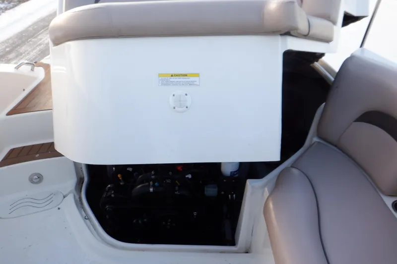 Slide: The Image of Interior view of a 2013 Hurricane SunDeck 2400 IO boat, showcasing seating and storage area. - 47