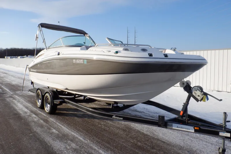 Slide: The Image of 2013 Hurricane SunDeck 2400 IO boat on trailer, parked on snowy ground. - 5