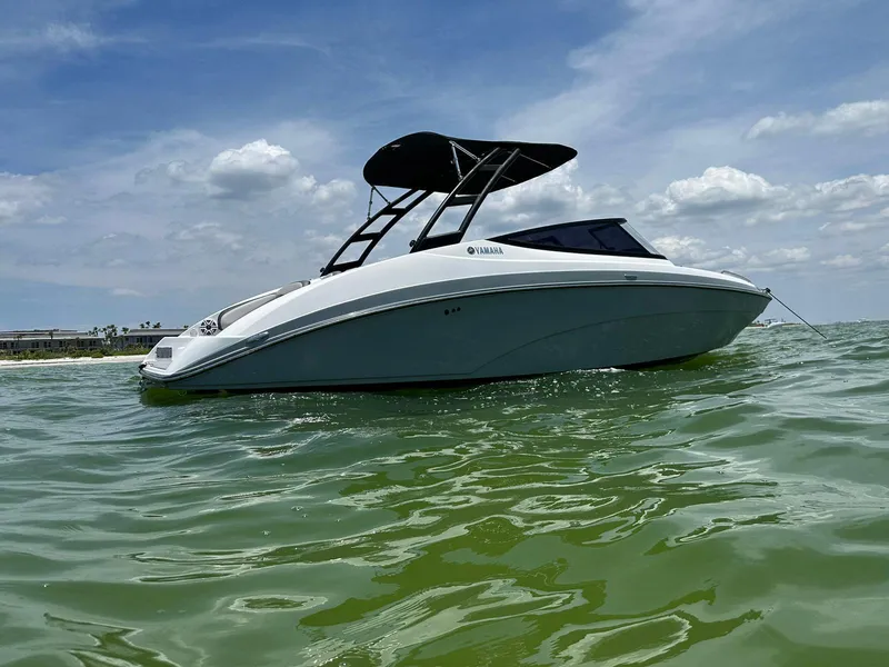 The Image of 2020 Yamaha AR240 boat on calm green water under a partly cloudy sky. - 0
