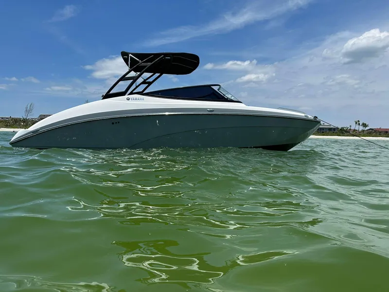 Slide: The Image of 2020 Yamaha AR240 boat on calm green water under blue sky. - 1
